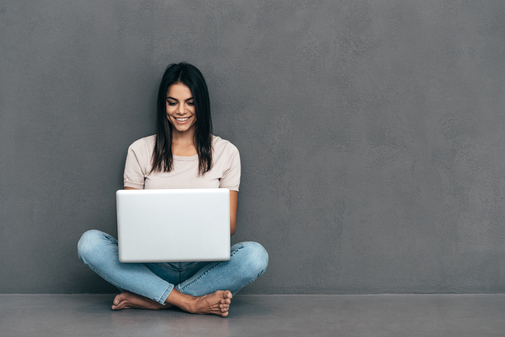 young woman sitting with laptop computer